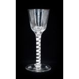 An 18th century opaque twist wine glass, the ogee bowl on a multi strand ribbon stem and conical