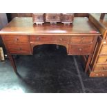 An Edwardian mahogany writing desk, fitted with five drawers