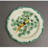 An English creamware plate with a scalloped rim with a green feathered border, painted with a Pea