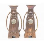 A pair of Art Nouveau copper candle stick with Prince of Wales feathers design