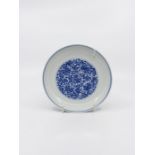A Chinese blue and white porcelain shallow dish, the exterior painted with delicate flowers and