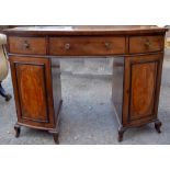 A 19th Century mahogany bow fronted kneehole desk, having three drawers and two doors, raised on