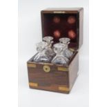 A four bottle decanter set in brass bound wooden case