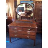 An Edwardian mahogany bedroom suite, comprising single mirrored door wardrobe, with top with a blind