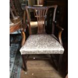 A George III mahogany open armchair, circa 1780, with an overstuffed seat, standing on square