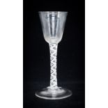 An 18th century opaque twist wine glass, the round funnel bowl on a multi spiral double twist