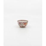 A late 18th Century Chinese tea bowl and saucer, hand painted with figures in a floral surround,