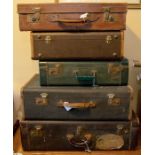 A set of 5 vintage suitcases, two with Cunard Line oval stickers for a jouirney on SS Parthia from