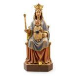 A 20th Century carved and adzed wooden icon of a Madonna and child, the crowned Madonna seated on
