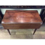 A George III mahogany Pembroke table, fitted with a frieze drawer, raised on square tapered legs,