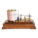 A mid 20th Century oak cased barograph, brass fittings, width 30cm, with spare paper charts