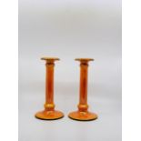 A pair of Art Deco orange lustre candlesticks, Crown Ducal ware. Column form with black banding