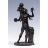 After the antique, a bronze study of a classical male with cymbals, standing beside a plinth with an