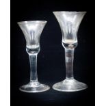 Two 18th century wine glasses, the bell shaped bowls with basal tear, on plain stems and conical