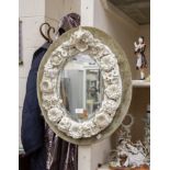 19th Century Continental foliate and flower encrusted mirror oval wall upon pale green velvet mount,