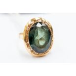 A gold and green stone ring, tests as 14k gold, the large oval stone tests as green spinel,