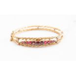 An 9ct gold ruby and garnet bracelet and diamond