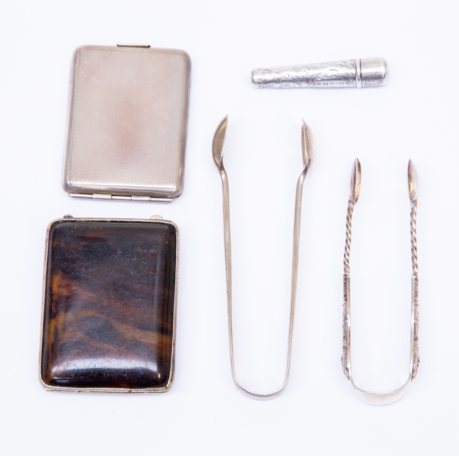 A collection of silver to include: two pairs of sugar tongs,