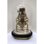An English brass skeleton clock with marble plinth and glass dome