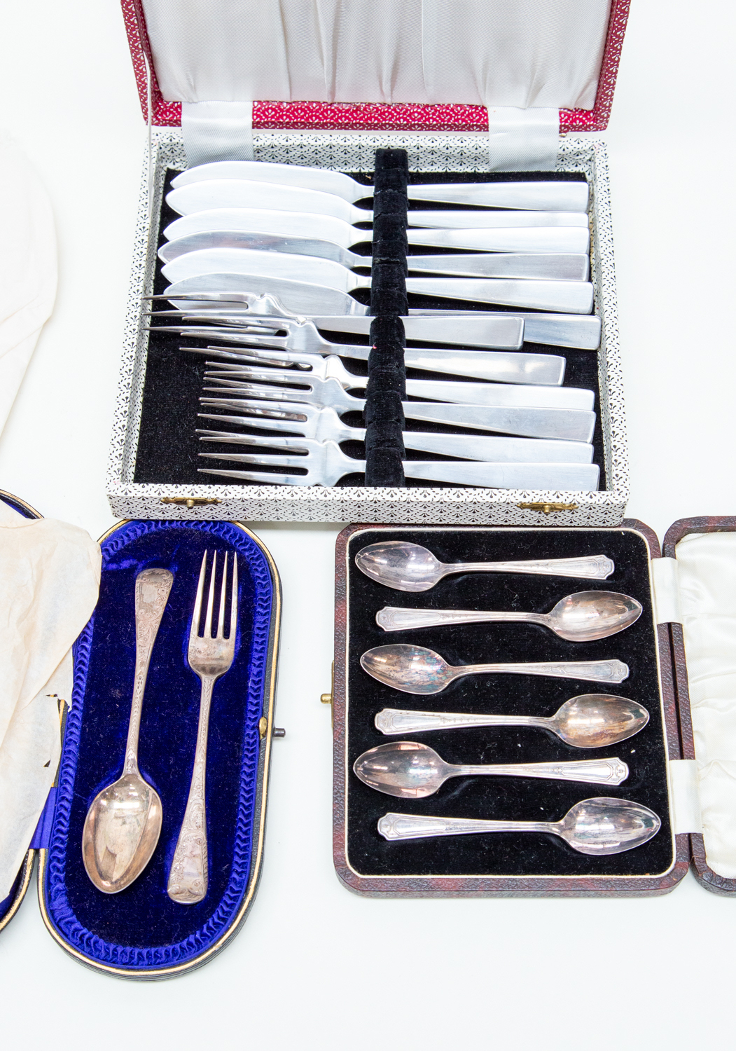 A collection of plated and silver items including a fish knife and fork set, spoons etc,