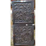 A pair of ornately carved wooden cabinet doors with a bird and foliage decoration