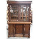 A mid 19th Century oak bookcase, of two-tier form, carved throughout,