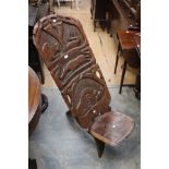 An Early 20th Century African carved two piece wooden chair,