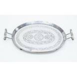 A Sudanese silver oval tray with handles, engraved design,