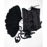 A lady's black corset, boned and studded, back and front laces, size 26 inch waist,