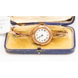 A 9ct rose gold 1930's ladies wristwatch on expander strap, white enamel dial,