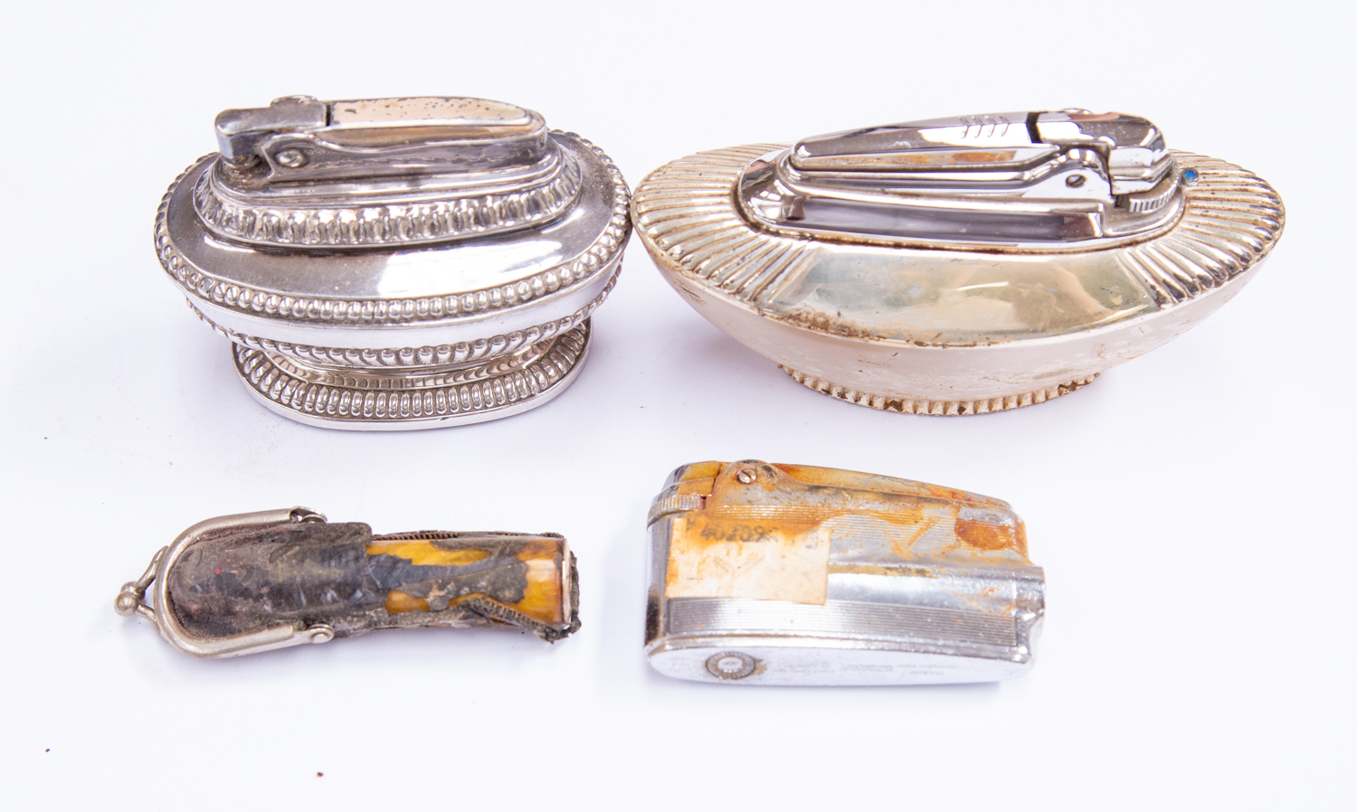 Three silver plated cigarette lighters,