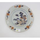 An 18th Century porcelain plate decorated in an Oriental style with cobalt blue and iron red,