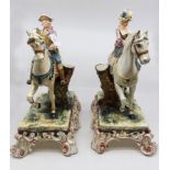 A pair of Austrian Majolica style figures of a lady and a gentleman on horse back,