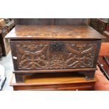 A small oak chest with a carved front