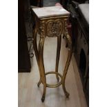 A gilt and marble top jardiniere stand