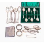 A mixed parcel lot of silver flatware, to include; cigarette case, napkin rings,