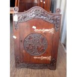 A small carved oak wall hanging corner cupboard