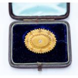 A Victorian diamond set gold brooch, granular, floral and leaf decoration, diamond set to centre,