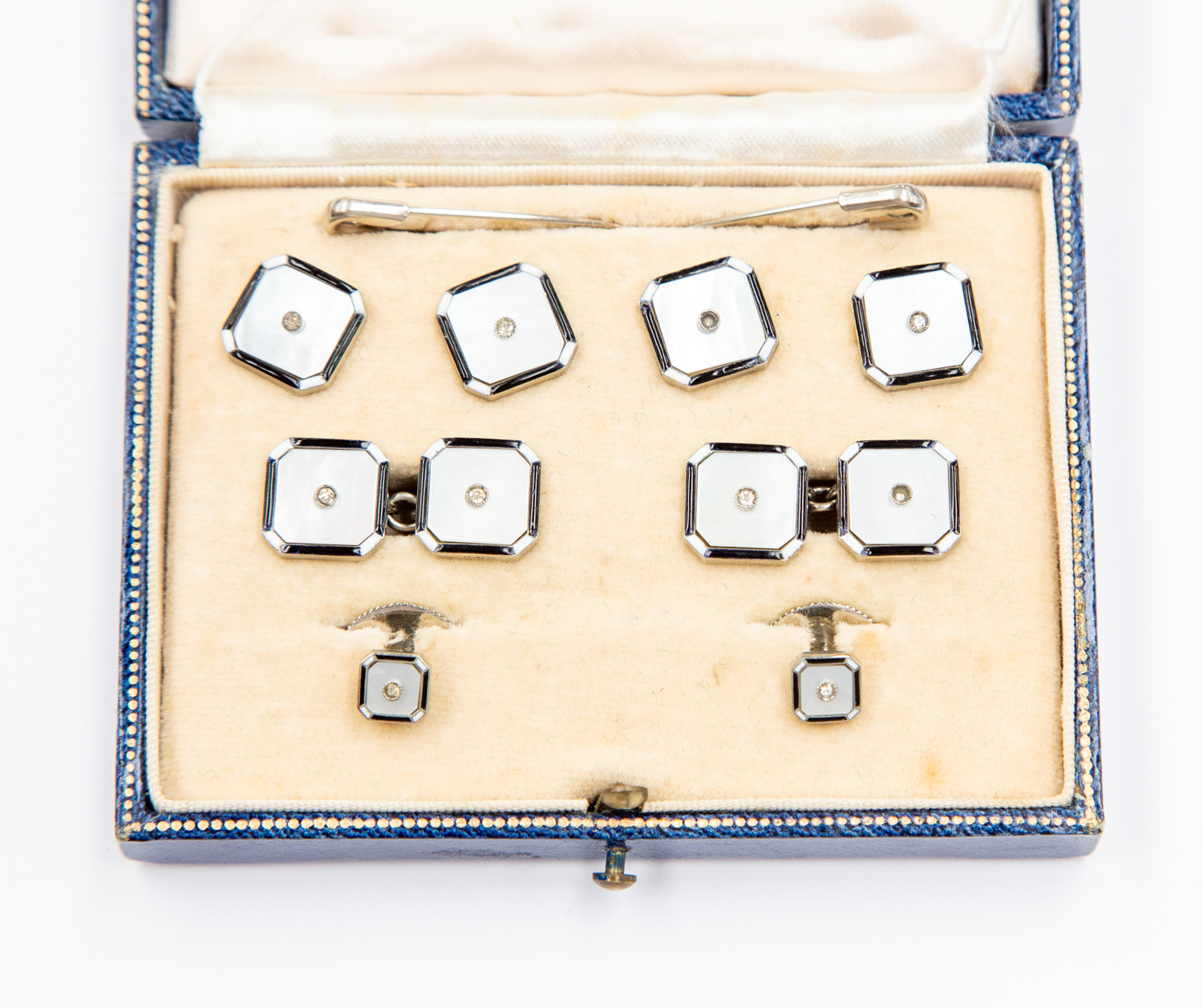 A set of mother of pearl white metal collar studs and buttons,