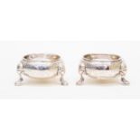 A pair of George II Baroque silver circular salts,