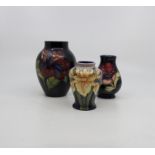 Moorcroft; a collection of three various baluster vases,