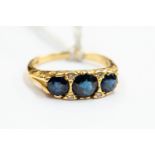 A Victorian sapphire and diamond ring, comprising three round sapphires, with diamond accents,