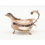 A George III silver sauce boat, acanthus C scroll handle on three stepped shell feel,