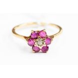 A 9ct gold diamond and ruby flowerhead ring, size M, gross weight approx 1.