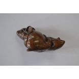 A treen netsuke of a rat with a squid,