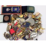 A large collection of enamel membership badges, medallions, etc. Some in silver.