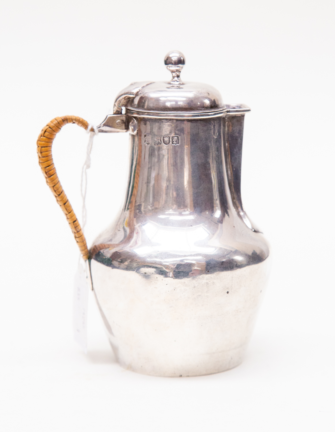 An Edwardian silver cream jug, makers mark rubbed, assayed London 1901, of circular baluster form,