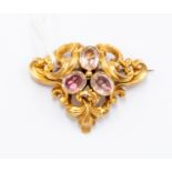 A Victorian trefoil brooch, scroll details set with three foil backed quartz,