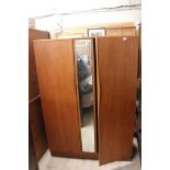 A 1970'S Teak Wardrober, fitted with mirror in between the doors.