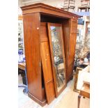 An Edwardian mahogany triple sectioned wardrobe, fitted with three doors,